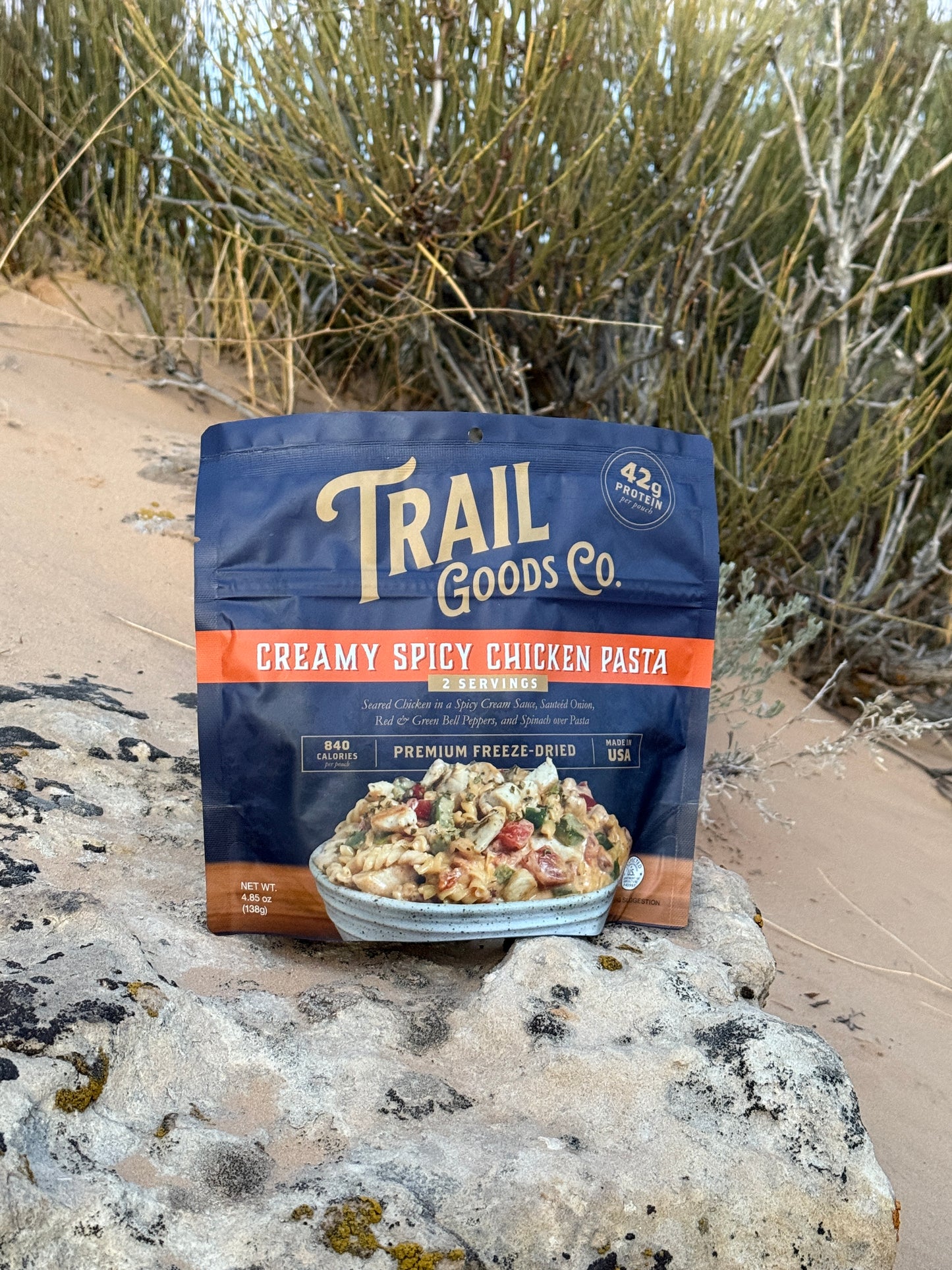 Trail Goods Co. Creamy Spicy Chicken Pasta served on a camping table during a backpacking adventure